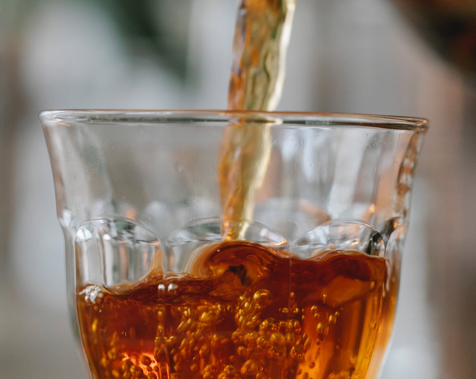 aromatic black tea pouring into glass