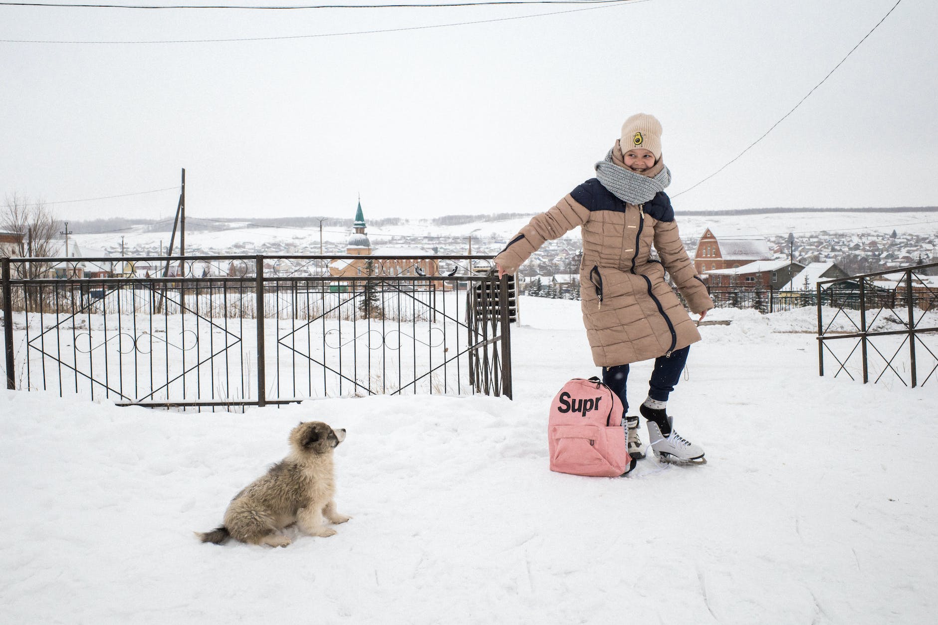 smiling girl putting on ice skates outdoors