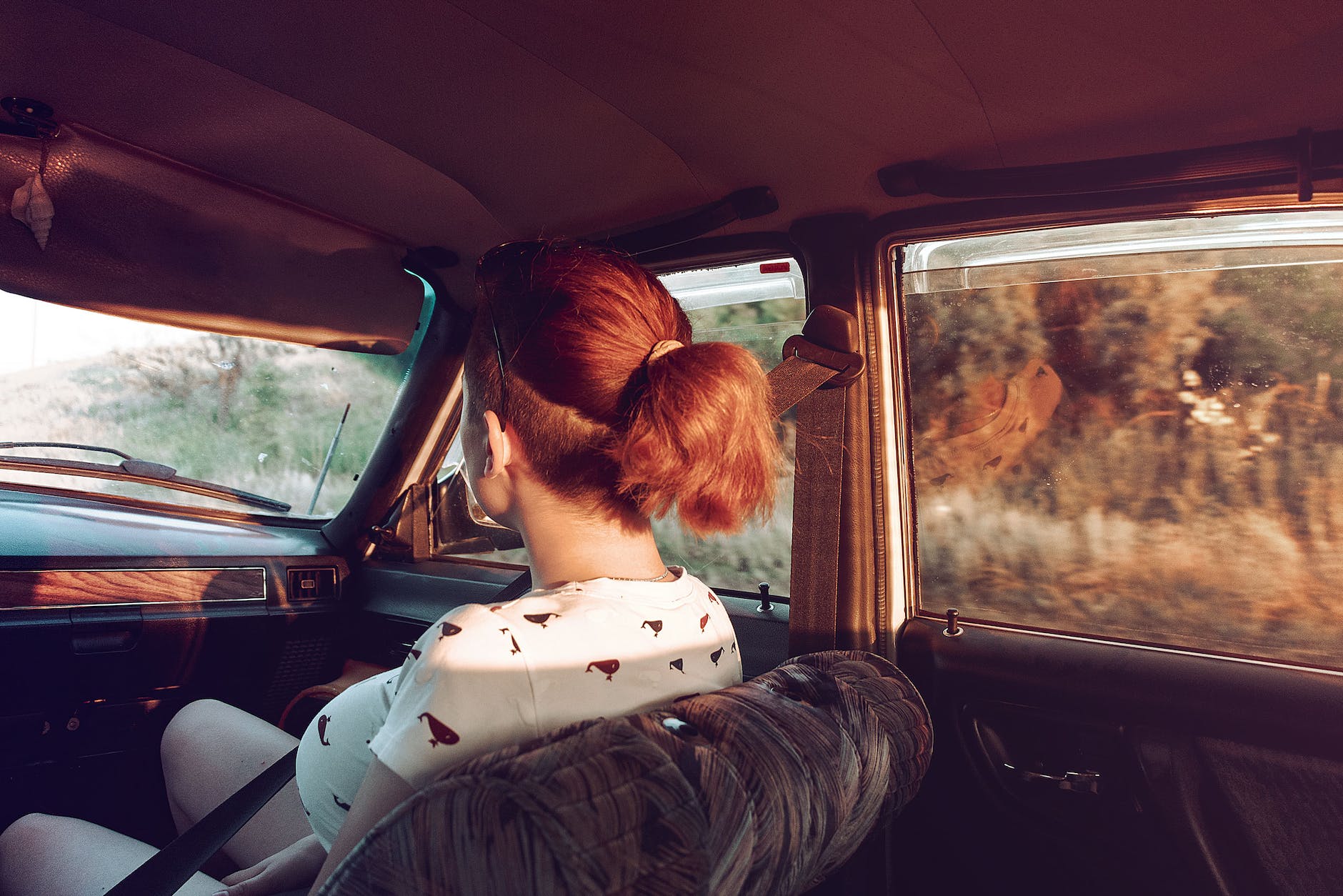 unrecognizable female passenger riding in car