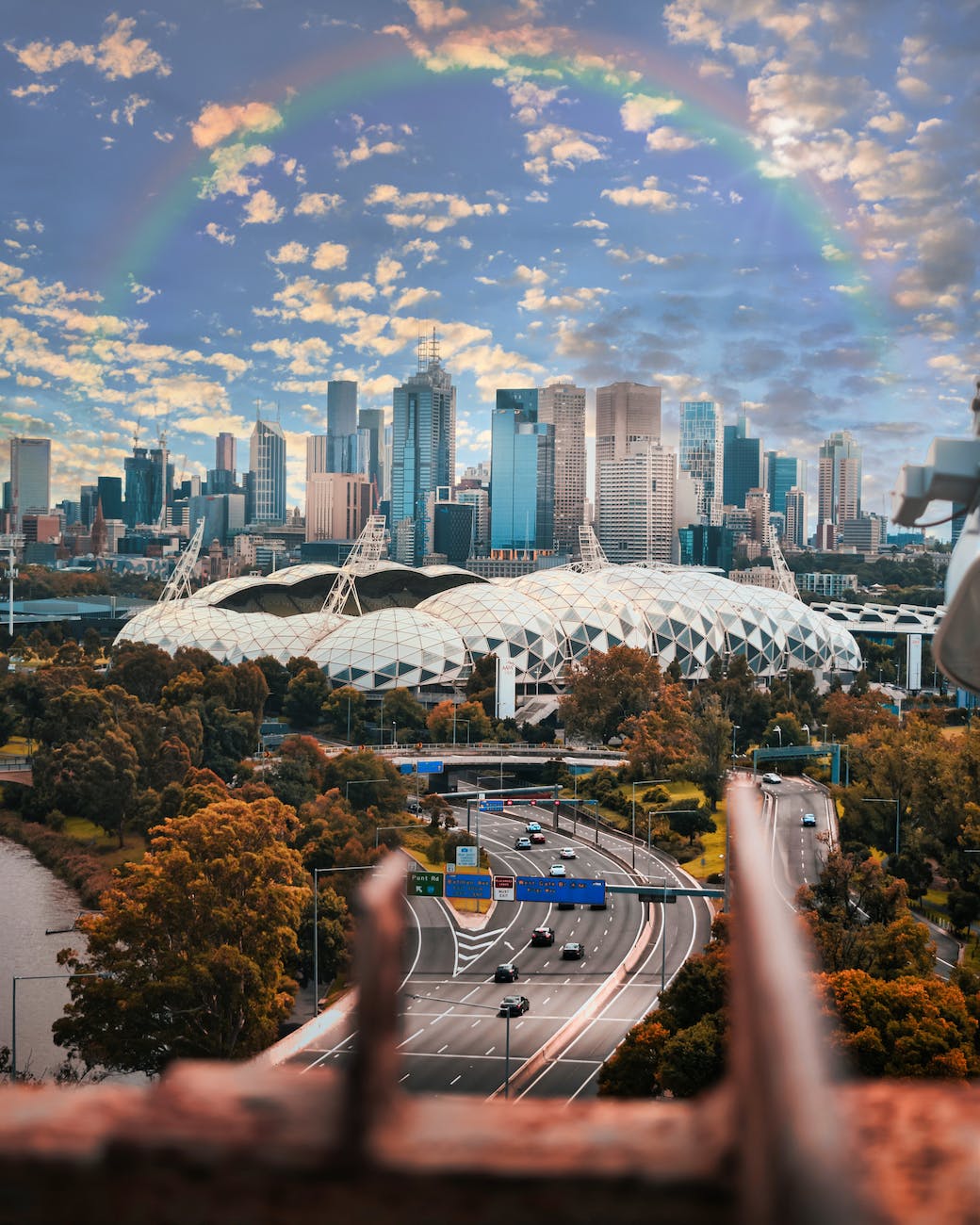 city buildings under the rainbow