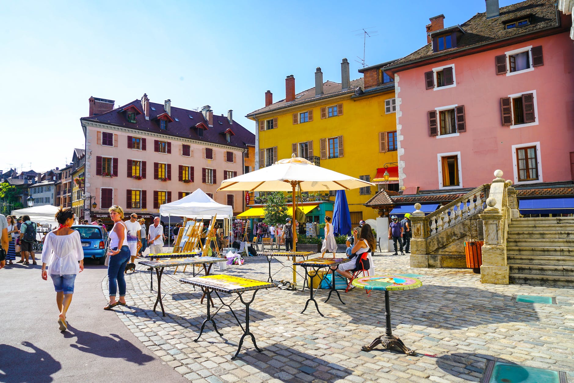 group of people near tables and parasol