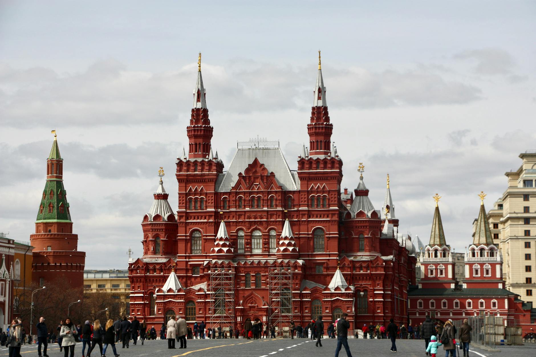 photo of people walking near the red square building