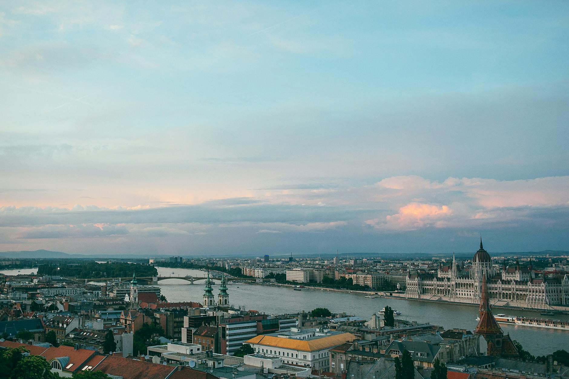 cityscape with old stone building facades under cloudy sky